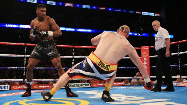 Anthony Joshua sends Inverness boxer Gary Cornish crashing to the canvas. Picture: PA