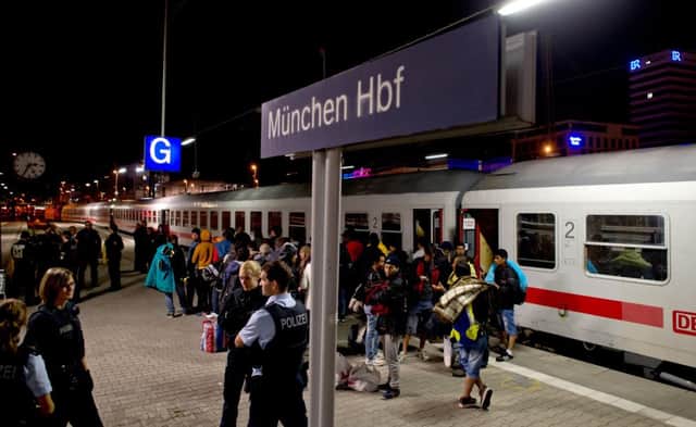 Refugees board a train in Munich. Picture: AP