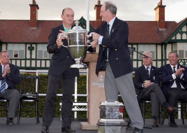 Captain Nigel Edwards Edwards receives the trophy from Royal Lytham captain Roger Berry. Picture: Getty