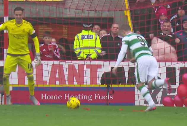 Leigh Griffiths sticks the penalty away despite Derek Russo's best efforts. Picture: Contributed