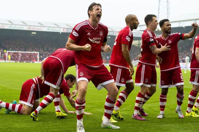 Ash Taylor celebrates after Paul Quinn's winner for Aberdeen. Picture: SNS