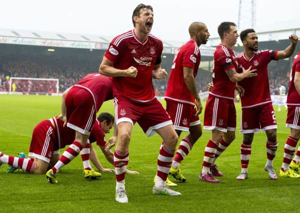 Ash Taylor celebrates after Paul Quinn's winner for Aberdeen. Picture: SNS