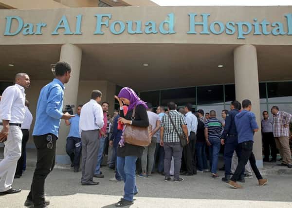 Egyptian journalists wait for information about tourists who were injured Sunday while on a desert safari trip, in front of the Dar Al Fouad Hospital in Cairo. Picture: AP