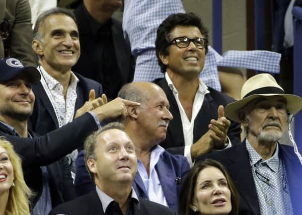 US actor Bradley Cooper, left, points out Sir Sean Connery as the Scot took in the US Open tennis final in New York. Picture: AP