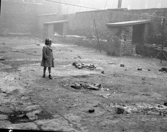 A child plays in the back court of a Florence Street tenement in 1962