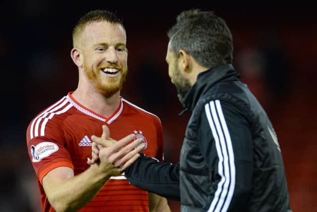 Derek McInnes congratulates match winner Adam Rooney after Aberdeen's 1-0 victory over Hamilton. Picture: SNS