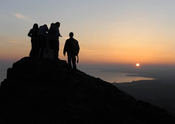 Students watch the sunrise from the summit of Arthurs Seat.
Picture: Neil Hanna