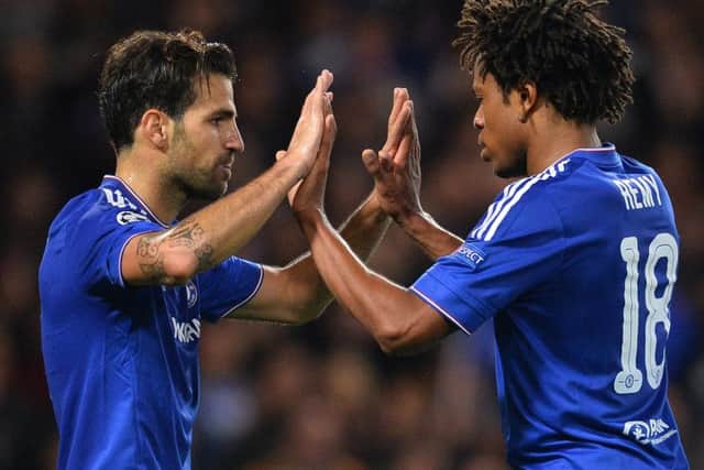 Cesc Fabregas (L) celebrates with striker Loic Remy after scoring his team's fourth goal. Picture: AFP/Getty