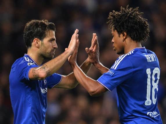 Cesc Fabregas (L) celebrates with striker Loic Remy after scoring his team's fourth goal. Picture: AFP/Getty