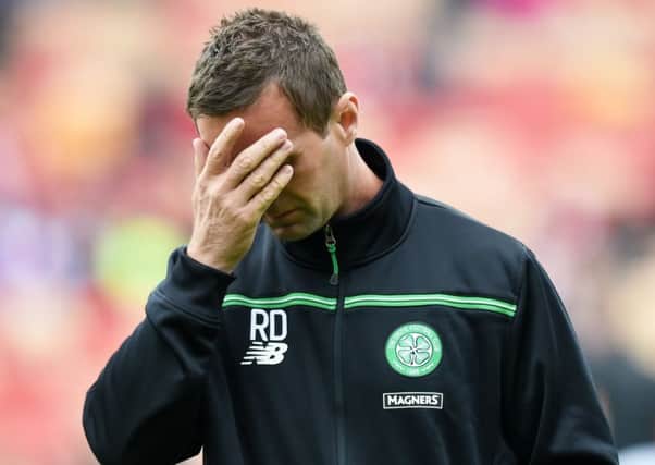 Deila looks dejected after his side's loss to Aberdeen. Picture: SNS