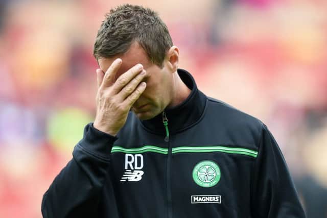 Deila looks dejected after his side's loss to Aberdeen. Picture: SNS