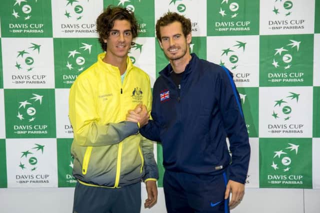 Andy Murray, right, with opening day opponent Thanasi Kokkinakis. Picture: SNS Group