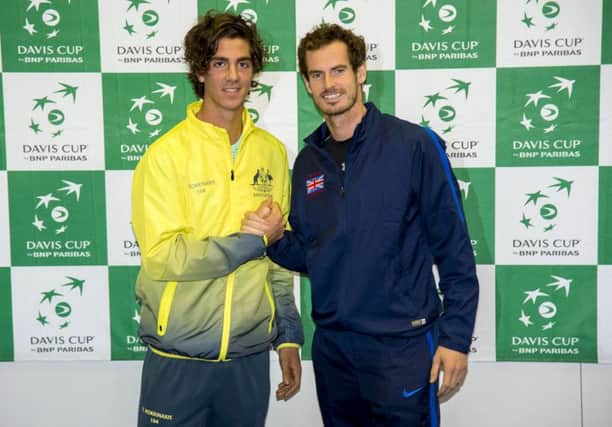 Andy Murray, right, with opening day opponent Thanasi Kokkinakis. Picture: SNS Group