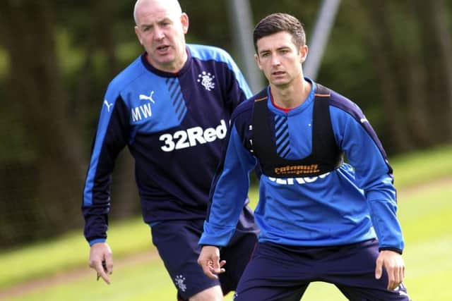 Manager Mark Warburton and Jason Holt train together at Murray Park yesterday. Picture: Rangers FC/PA