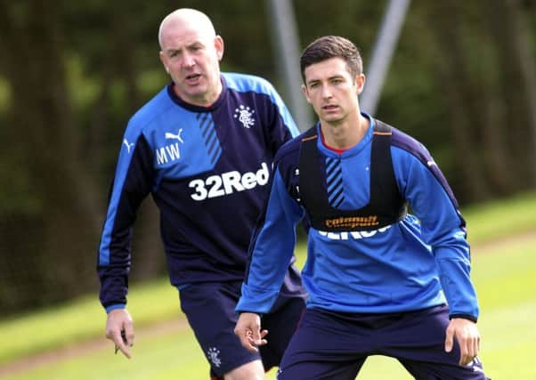 Manager Mark Warburton and Jason Holt train together at Murray Park yesterday. Picture: Rangers FC/PA