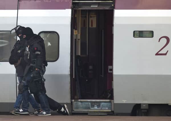 Heavily armed Dutch police drag a man from the Paris-bound train in Rotterdam after he was alleged to have boarded with a bomb. Picture: AP