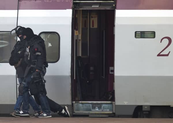Heavily armed Dutch police drag a man from the Paris-bound train in Rotterdam after he was alleged to have boarded with a bomb. Picture: AP