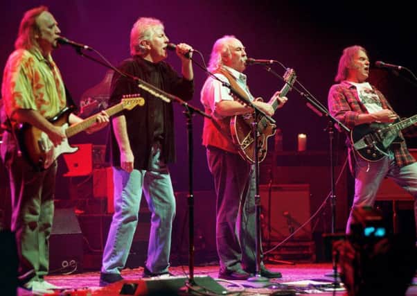 Stephens Stills, Graham Nash and David Crosby performing with Neil Young (right). Picture: AP