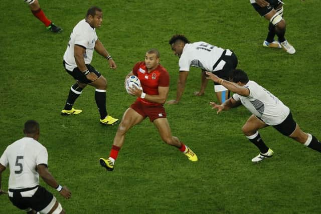 Englands Jonathan Joseph finds himself surrounded by a clutch of Fiji players during the opening match of the 2015 World Cup. Picture: AP