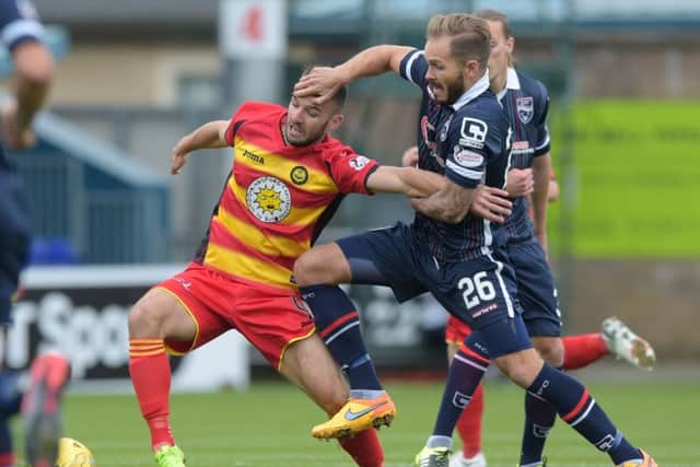 Martin Woods (right) closes down Partick's Sean Welsh. Picture: SNS Group