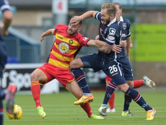 Martin Woods (right) closes down Partick's Sean Welsh. Picture: SNS Group