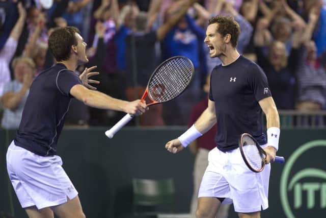 Andy and Jamie Murray celebrate after winning their doubles match in five sets. Picture: Ian Rutherford