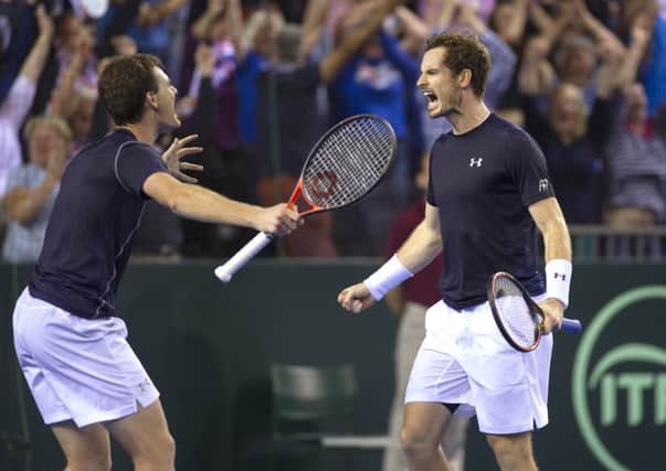 Andy and Jamie Murray celebrate after winning their doubles match in five sets. Picture: Ian Rutherford