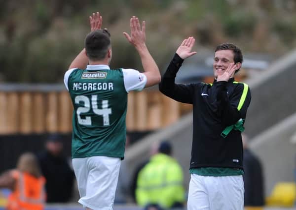 Hibs matchwinner Liam Henderson celebrates with teammate Darren McGregor at fulltime in Livingston.  Picture: Neil Hanna