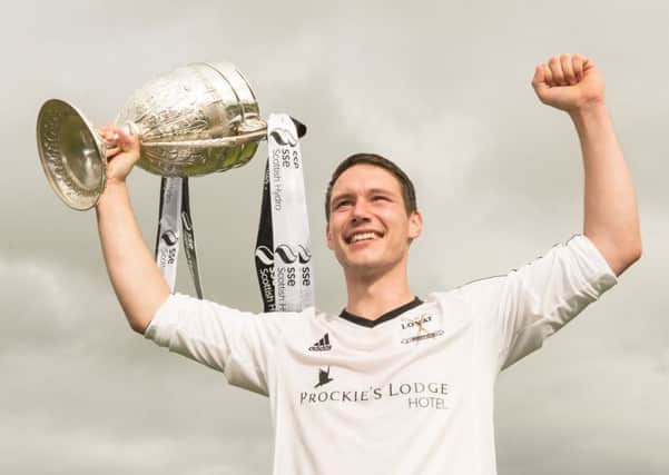 Lovat captain Daniel Grieve lifts the 2015 Camanachd Cup after his sides 21 win against Kyles Athletic  in Oban. Picture: Neil Paterson