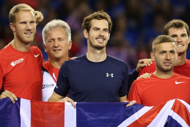 Andy Murray celebrates winning his singles match against Bernard Tomic of Australia with his fellow GB teammates. Picture: PA