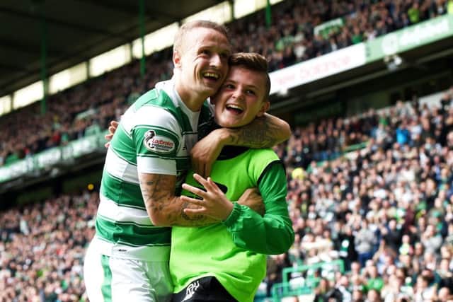 Celtic striker Leigh Griffiths celebrates with ball boy Ross Hamilton. Picture: SNS