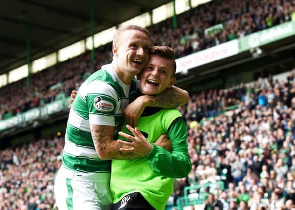Celtic striker Leigh Griffiths celebrates with ball boy Ross Hamilton. Picture: SNS