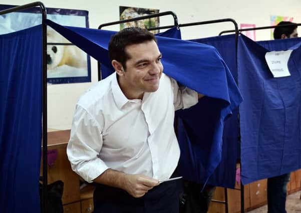 Leader of the Greek radical-left Syriza party and former Prime Minister Alexis Tsipras exits a polling booth in central Athens. Picture: AFP/Getty Images