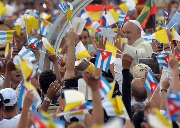 Pope Francis greeted by worshippers as he arrives at Revolution Plaza in Havana during his first visit to Cuba yesterday. Picture: AFP/Getty Images