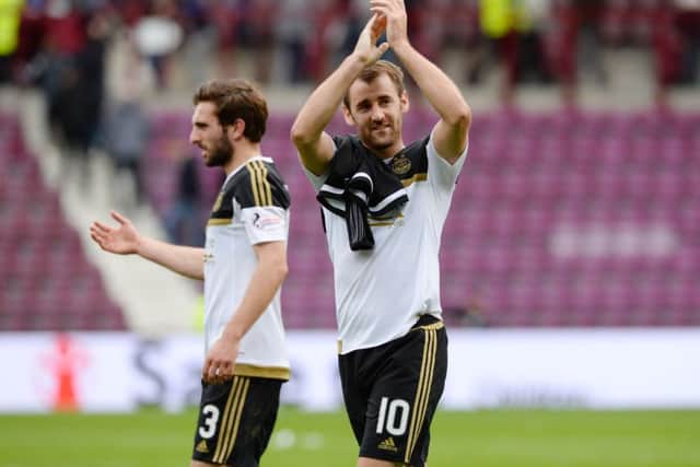 Aberdeens Niall McGinn applauds the travelling Dons supporters. Picture: SNS