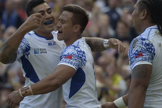 Standoff Tusi Pisi, left, celebrates Tim NanaiWilliams try. Picture: AFP/Getty Images