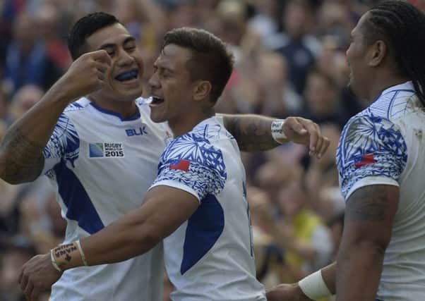 Standoff Tusi Pisi, left, celebrates Tim NanaiWilliams try. Picture: AFP/Getty Images