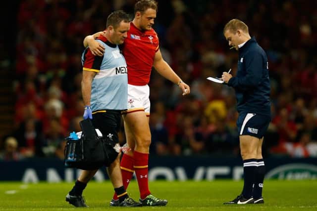 Wales centre Cory Allen is helped off after tearing his hamstring. Picture: Getty