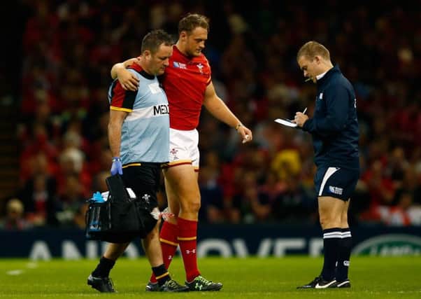 Wales centre Cory Allen is helped off after tearing his hamstring. Picture: Getty