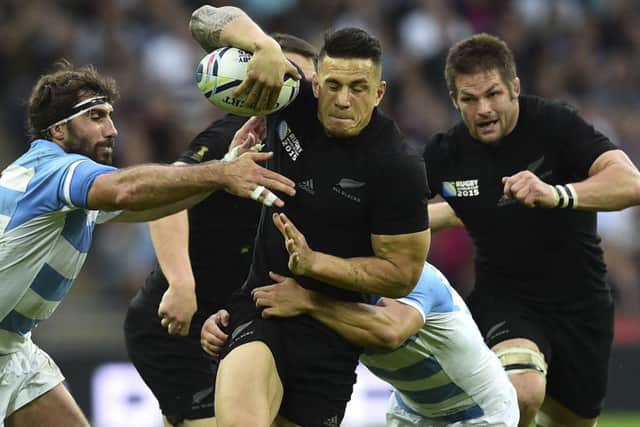 Influential New Zealand centre Sonny Bill Williams strives to shake off Argentine attentions. Picture: AFP/Getty Images