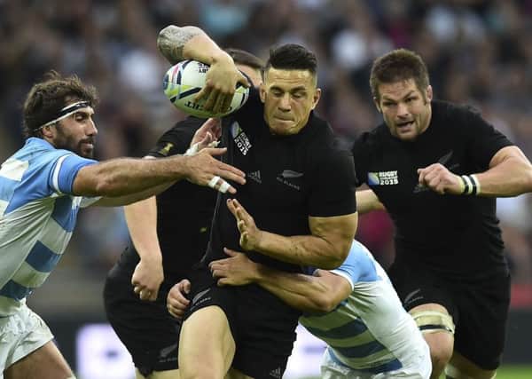 Influential New Zealand centre Sonny Bill Williams strives to shake off Argentine attentions. Picture: AFP/Getty Images