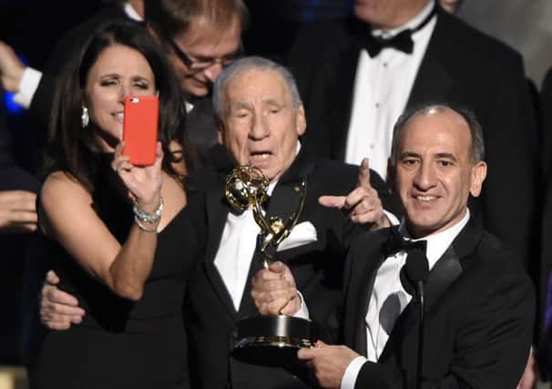 Veep star Julia Louis-Dreyfus snaps creator Armando Iannucci receiving the gong for comedy from Mel Brooks. Picture: AP