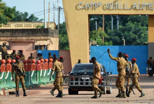 Burkina Faso army troops stand guard outside Guillaume Ouedraogo military camp in the capital, Ouagadougou, yesterday. Picture: AFP/Getty