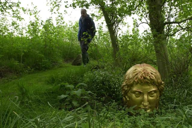 Poet and artist Ian Hamilton Finlay, pictured in 2000, in his garden Little Sparta in South Lanarkshire. Picture: Robert Perry