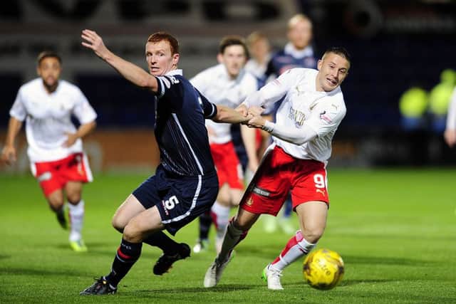 John Baird pulls back Ross County defender Scott Boyd. Picture: Michael Gillen