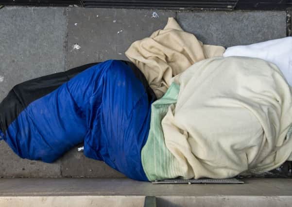 A homeless person sleeps rough behind the Storytelling Centre in Edinburgh Picture: Ian Georgeson