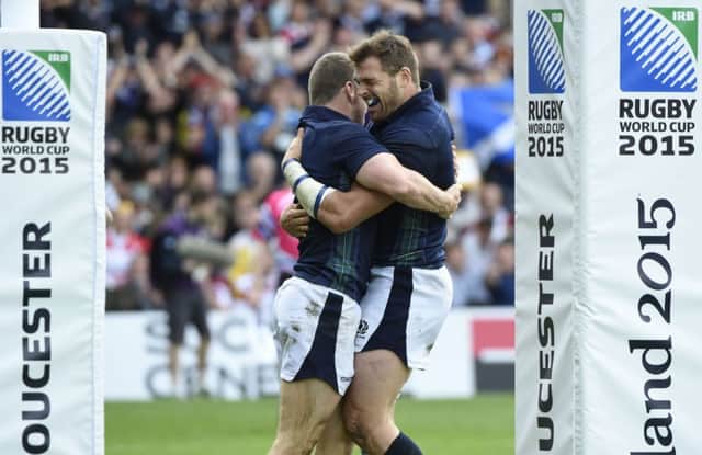 Mark Bennett, left, celebrates scoring for Scotland. Picture: AFP/Getty Images
