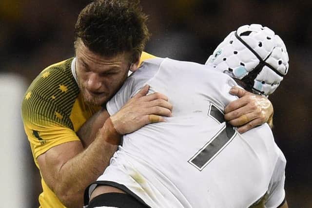 Australia wing Rob Horne, left, blocks Fiji flanker Akapusi Qera at the Millennium Stadium. Picture: AFP/Getty