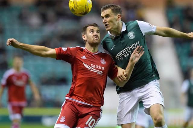Aberdeen's Niall McGinn (left) tussles with Paul Hanlon. Picture: SNS