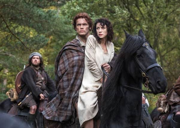 Caitriona Balfe as Claire Randall, right, and Sam Heughan as Jamie Fraser, centre, and Grant O'Rourke as Rupert MacKenzie in Starz' show Outlander. Picture: AP